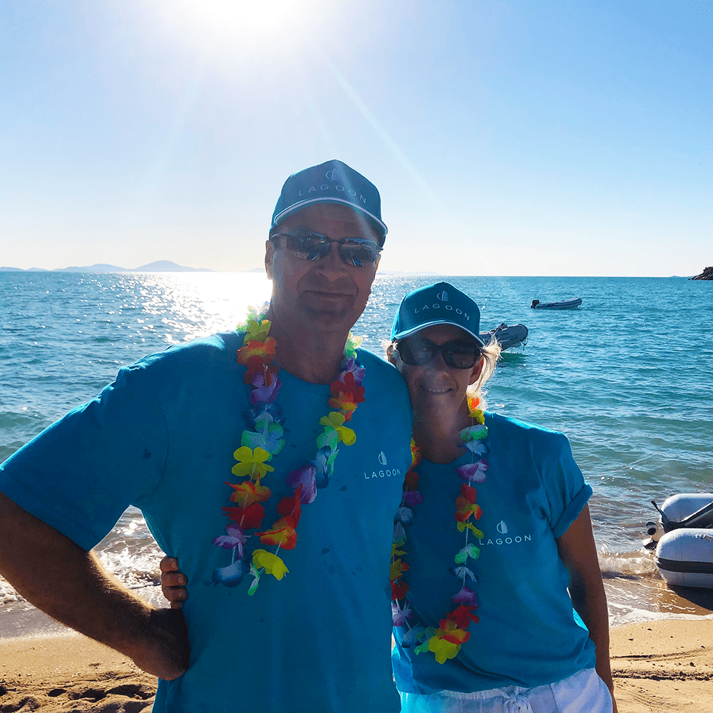 Lagoon Owners hugging and smiling at the event called Lagoon Escaped on the beach